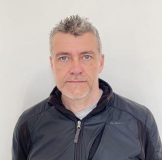 A headshot of Phil James